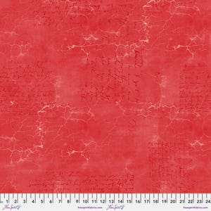 May include: Red fabric with a distressed, cracked texture and faded handwritten text throughout. The fabric has a vintage, antique look.