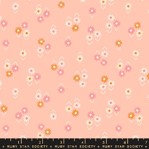 May include: A pink fabric with a repeating pattern of white, orange, and pink flowers. The flowers are arranged in a diamond pattern with white lines forming a chevron pattern.
