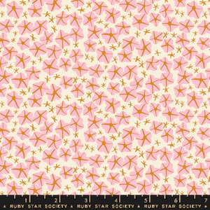 May include: A white fabric with a repeating pattern of pink flowers and gold stars. The fabric is marked with a ruler in inches and the text "RUBY STAR SOCIETY".