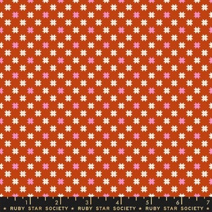 May include: A red fabric with a repeating pattern of white and pink four-pointed stars. The fabric has a subtle texture and is perfect for quilting, sewing, or crafting.