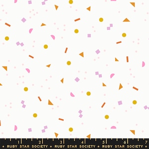 May include: White fabric with a repeating pattern of pink, orange, and gold confetti shapes. The shapes include circles, squares, triangles, and rectangles.