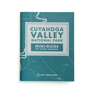 May include: A teal blue mini-guide booklet with the text "CUYAHOGA VALLEY NATIONAL PARK MINI-GUIDE THE 19-TRAIL CHALLENGE" and a logo for "FREE PERIOD PRESS".