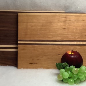 Made in Maine, Beautiful hand made  cutting board with contrasting stripes.   9” x 14”