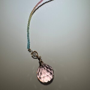 May include: A rainbow colored beaded chain with a clear pink crystal ball pendant.