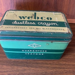 May include: A vintage green tin box of Webco dustless crayons. The box is labeled "Webco dustless crayon" and "Satisfactory for all blackboards". The bottom of the box says "Guaranteed Crayons".