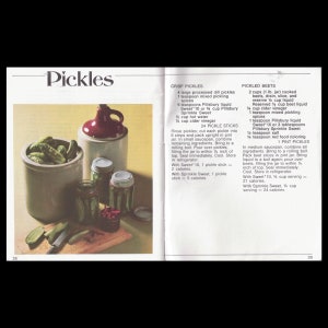 May include: A vintage cookbook page with recipes for pickles and pickled beets. The page features a photo of a jar of pickles and a jar of pickled beets. The recipes include ingredients like dill pickles, cider vinegar, and Pillsbury Sprinkle Sweet.
