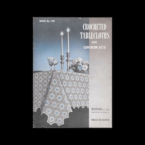 May include: Vintage crochet pattern book cover titled "Crocheted Tablecloths and Luncheon Sets." The cover features a white and blue daisy-patterned tablecloth, lit candles, and text that reads "Book No. 179" and "Price 10 Cents."