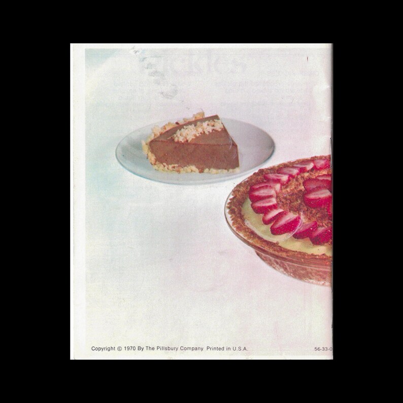 May include: Two slices of pie on white plates. One slice is chocolate with coconut flakes on top. The other slice is a yellow custard pie with sliced strawberries on top.
