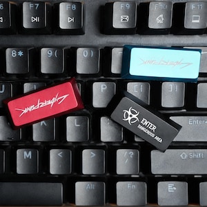 May include: Close-up of a black keyboard with custom keycaps. One red keycap has the word "Cyberpunk" in white. A blue keycap also has the word "Cyberpunk" in a glowing font. A black keycap reads "ENTER DANGEROUS AREA".