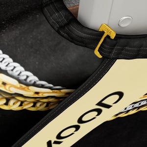 May include: Black baseball cap with a gold chain design and the word "ICOP" printed on the front. The cap has an adjustable strap with a gold buckle.