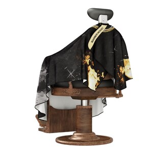 May include: A black barber's cape with a gold chain design and the text "BARBER MOOD" on the front. The cape is draped over a wooden barber's chair.