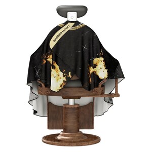 May include: Black barber's cape with a gold and white flame design and the text "Barber Mood".