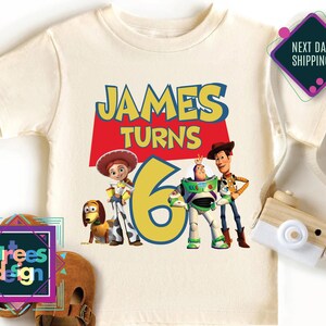 a white shirt with a picture of the characters of toy story