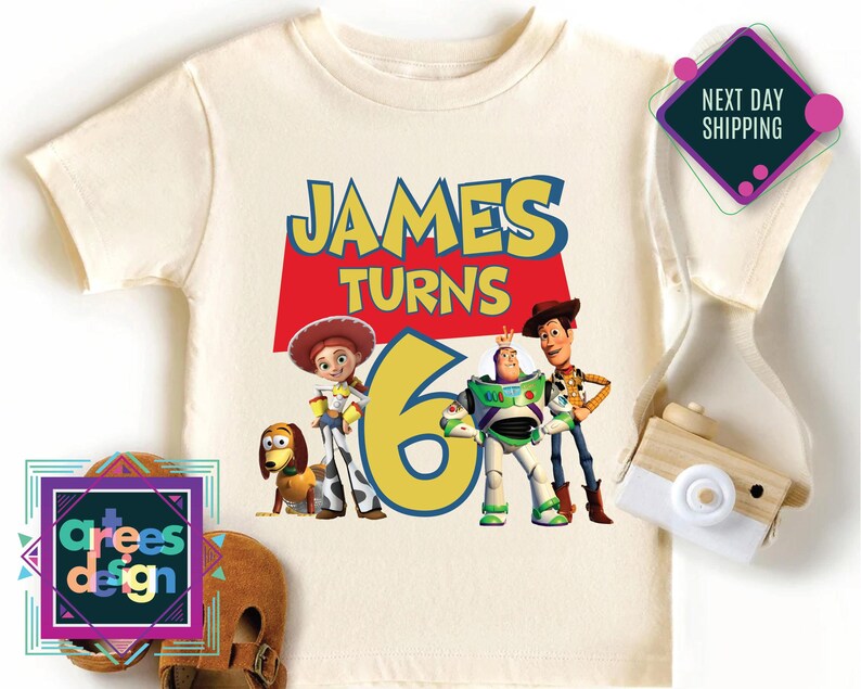 a white shirt with a picture of the characters of toy story