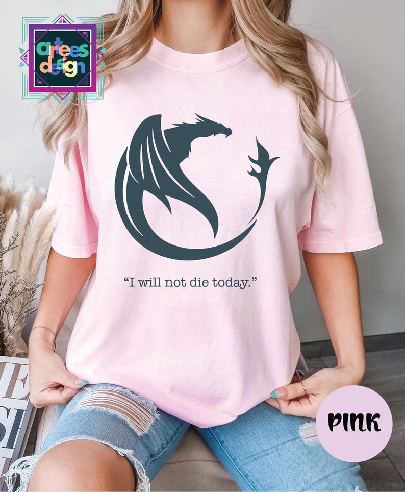 a woman wearing a pink shirt with a dragon on it