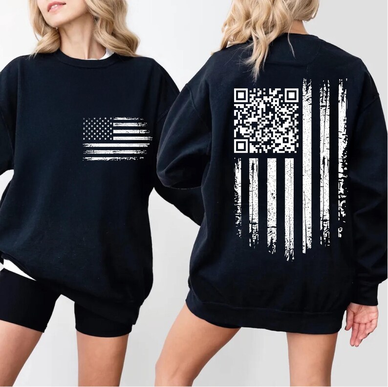 two black sweatshirts with white designs on the back. The design on the back includes an American flag and a QR code.