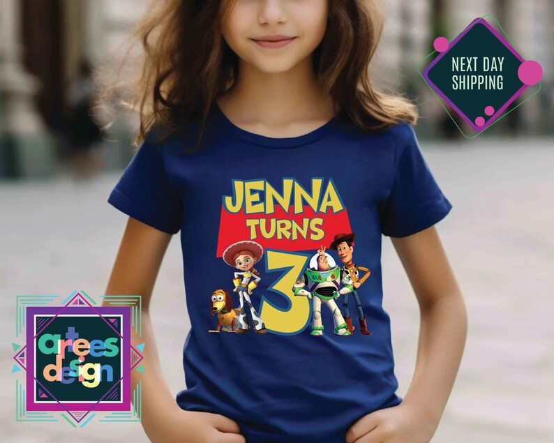 a young girl wearing a t - shirt with a picture of the characters from the