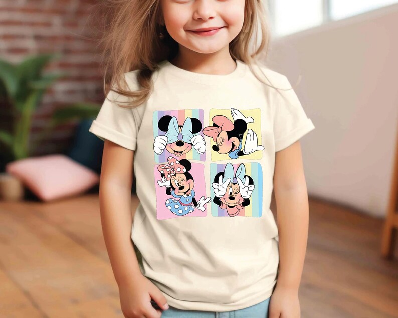a little girl wearing a mickey mouse t - shirt