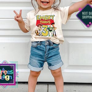 a little girl standing in front of a garage door