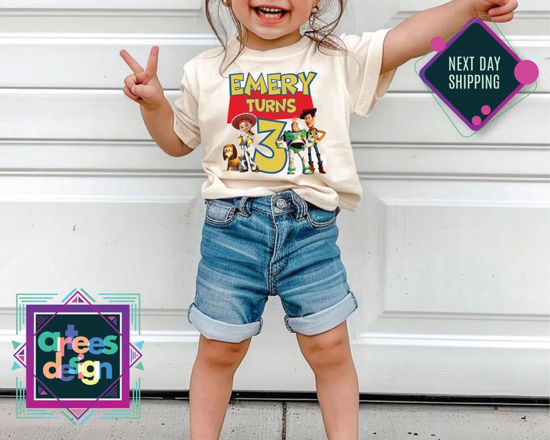 a little girl standing in front of a garage door