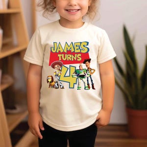 a little girl standing in front of a book shelf