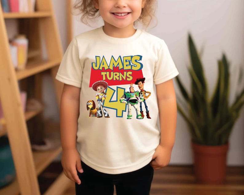a little girl standing in front of a book shelf