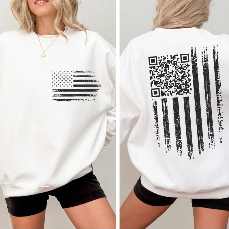 A white sweatshirt with a black graphic design on the back, depicting an American flag with a QR code.