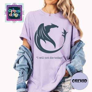 a woman wearing a purple t - shirt with the words i will not die today