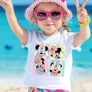 a little girl wearing sunglasses and a minnie mouse shirt