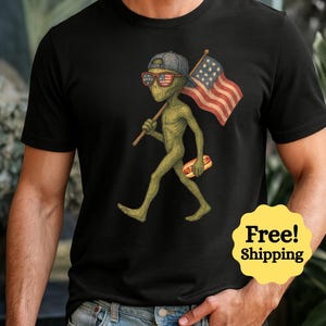 Camiseta vintage del 4 de julio con la bandera estadounidense y un extraterrestre. Regalo patriótico.