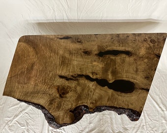 44” long x 25 1/2” wide, 1 5/8”. Myrtle wood burl live edge coffee table