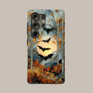 May include: A rectangular smartphone case featuring a stained glass style design of a full moon in a pale yellow sky, surrounded by tall trees and autumn foliage in shades of orange and brown, with several black bat silhouettes flying.