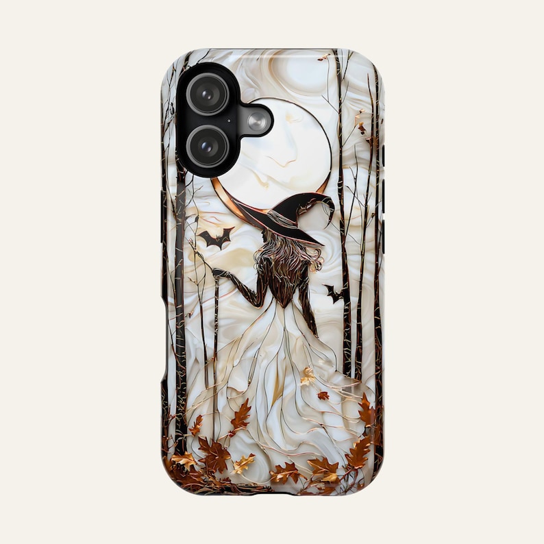 May include: A phone case with a witch design, featuring a witch in a white dress and black hat, set against a full moon and trees. Includes bats and autumn leaves, with a marbled background.