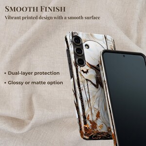 May include: A smartphone case with a white and brown abstract design, featuring a bat and tree branches. The case has a smooth finish and dual-layer protection. The text reads "SMOOTH FINISH" and "Vibrant printed design with a smooth surface."