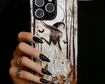 May include: A phone case featuring a detailed illustration of a figure in a wide-brimmed hat and flowing white gown standing in a forest of dark trees under a large moon. The design includes small flying bats and scattered golden autumn leaves.