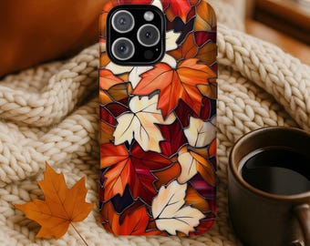May include: A rectangular smartphone case featuring a stained glass pattern of overlapping maple leaves in shades of orange, deep red, cream, and dark brown. The design includes black outlines separating each leaf shape, creating a mosaic effect.