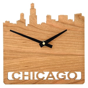 May include: A wooden clock with a black clock hand and the word "CHICAGO" cut out in the wood. The clock is shaped like the Chicago skyline.