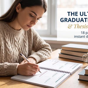 May include: A spiral-bound planner titled THE ULTIMATE GRADUATE SCHOOL & Thesis Planner with 18 pages, featuring white paper with black grid lines and text, resting on a wooden desk alongside stacked books and a ceramic mug.