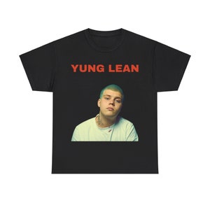 May include: Black t-shirt with a red print of "YUNG LEAN" and a photo of a man with green hair.
