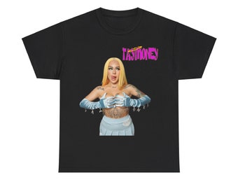 May include: Black t-shirt with a graphic of a woman with blonde hair wearing a blue skirt and blue gloves. The text "TAYMONEY" is printed in pink on the shirt.