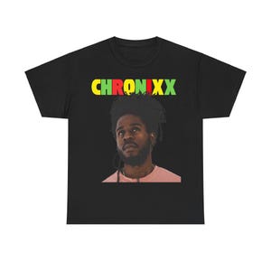 May include: Black t-shirt featuring a red, yellow and green graphic of the word "CHRONIXX" and a portrait of a man with dreadlocks.