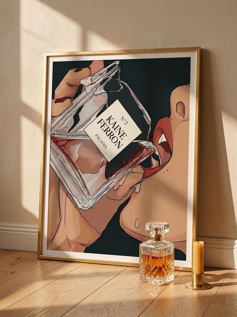 May include: Art print of a woman drinking from a perfume bottle. The bottle is labeled "KAINE FERRON" and "PALADIA". A second perfume bottle and a candle are on the wooden floor. The artwork is in a gold frame.