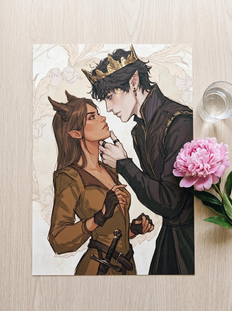 May include: An art print featuring a couple in a fantasy setting. The male figure wears a gold crown and dark clothing, while the female figure has horns and a brown outfit. A pink peony and a glass of water are in the background.
