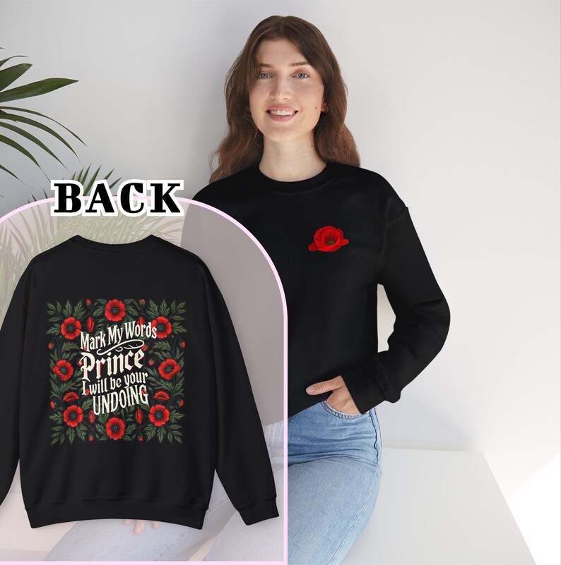 May include: Black sweatshirt with a floral design and the text "Mark My Words Prince I will be your Undoing" on the back. A single red poppy is embroidered on the front of the sweatshirt.