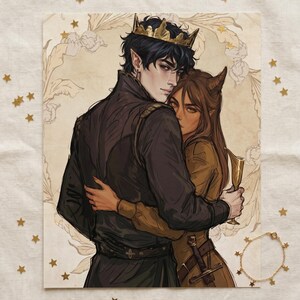 May include: An illustration of two figures embracing, one wearing a gold crown. The figures are depicted with dark hair and pointed ears. The artwork has a fantasy theme, with a sword and a gold bracelet with star charms visible.