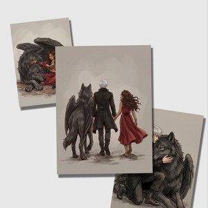 May include: Three art prints featuring fantasy illustrations. One print shows a woman in a red dress with a wolf and a winged wolf. Another depicts a couple walking with a winged wolf. The third print shows a man hugging a winged wolf.