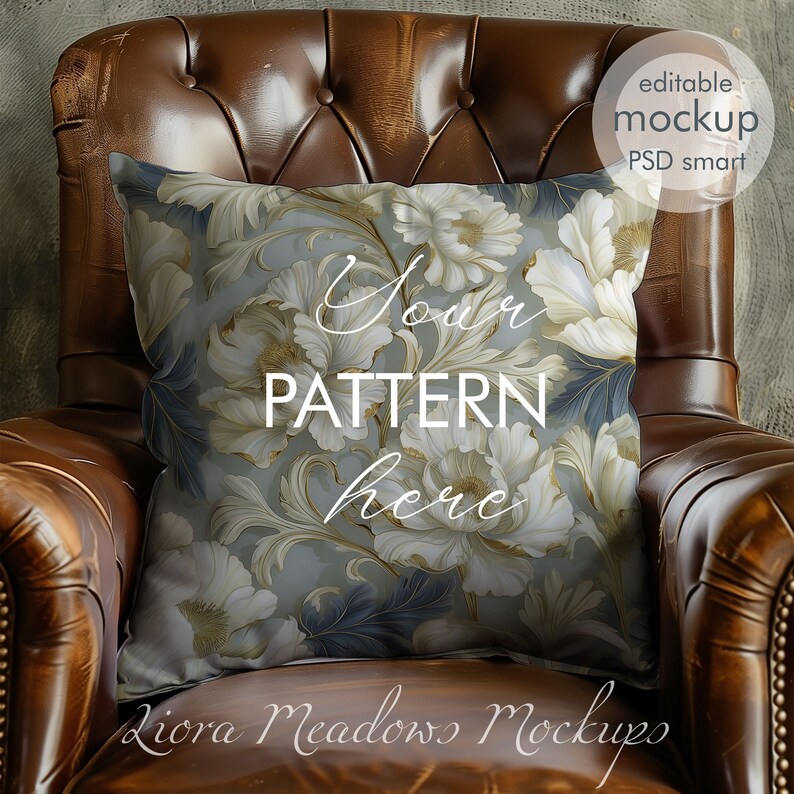 May include: A white and gold floral patterned pillow on a brown leather armchair. The pillow has the text "Your Pattern Here" on it.
