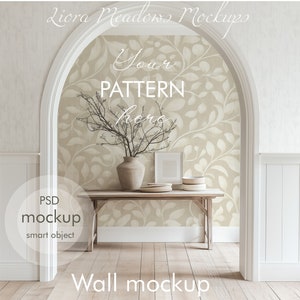 May include: A wall mockup scene featuring a wooden table with a vase and framed art. The background showcases a beige wallpaper with a leaf pattern. The scene is framed by an archway and includes the text "Your Pattern here" and "Wall mockup".
