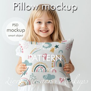 May include: A child holds a white pillow with a colorful pattern of rainbows, stars, and clouds. The text "Your pattern here" is printed on the pillow.