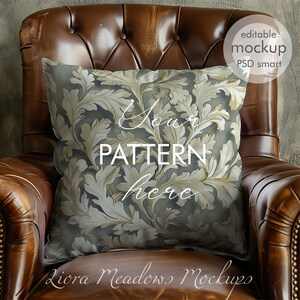 May include: A brown leather armchair with a decorative pillow featuring a gold and gray floral pattern. The pillow has the text "Your Pattern Here" on it. The image is a mockup for a pillow design.